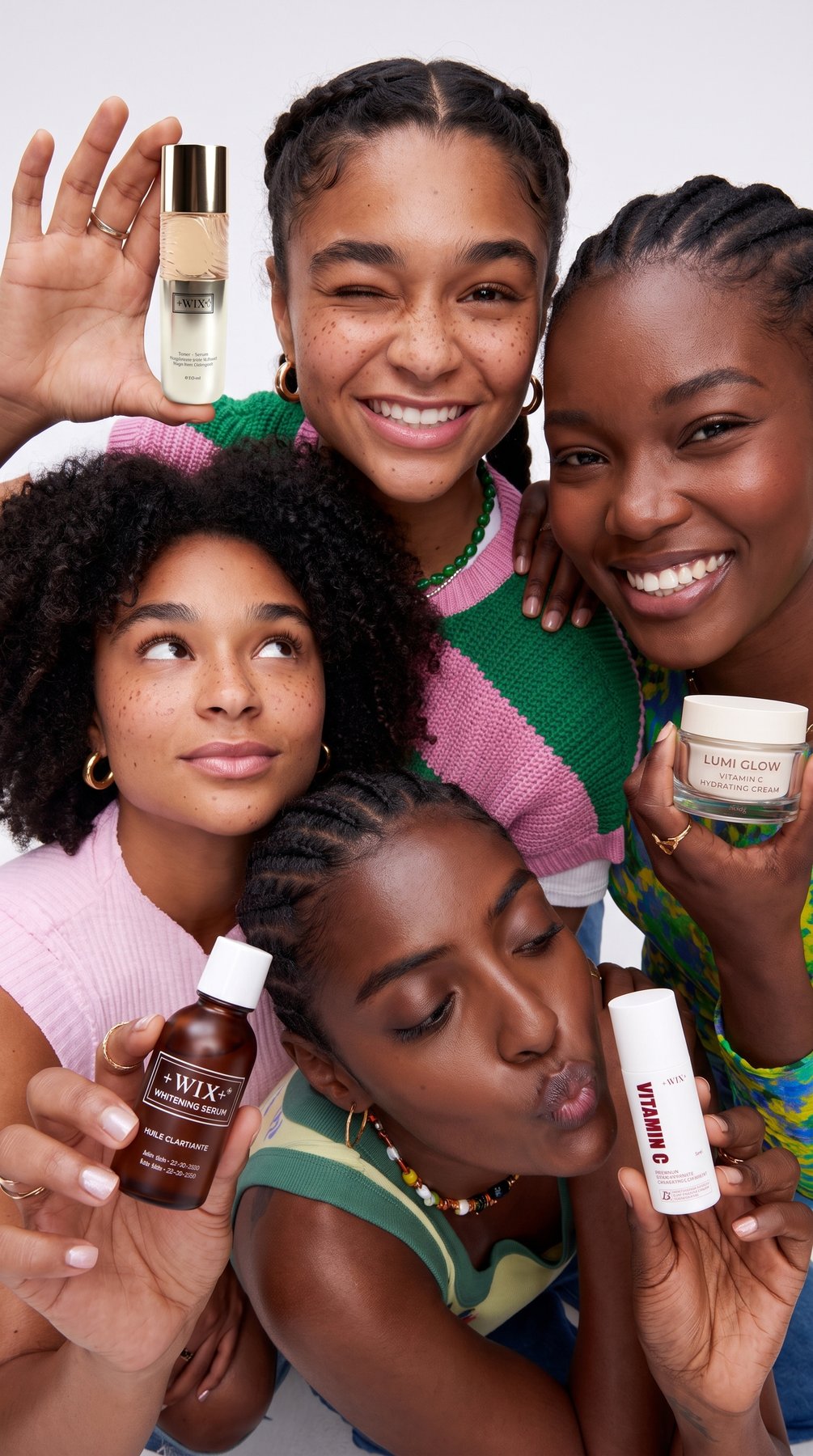 Friends holding +WIX+ serums and creams